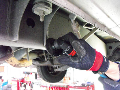 a mechanic working on a vehicle under a vehicle