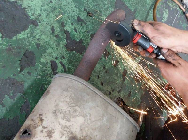 a person using a grinder on a piece of metal